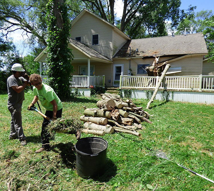Workers attend to home damage